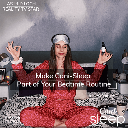 Alt=“Astrid Loch using CBD sleep oil in bed wearing pyjamas and sleeping mask”