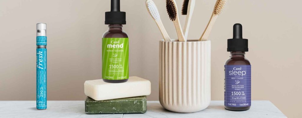 CBD oral spray supplement next to CBD oil tinctures, soap bars and toothbrushes“