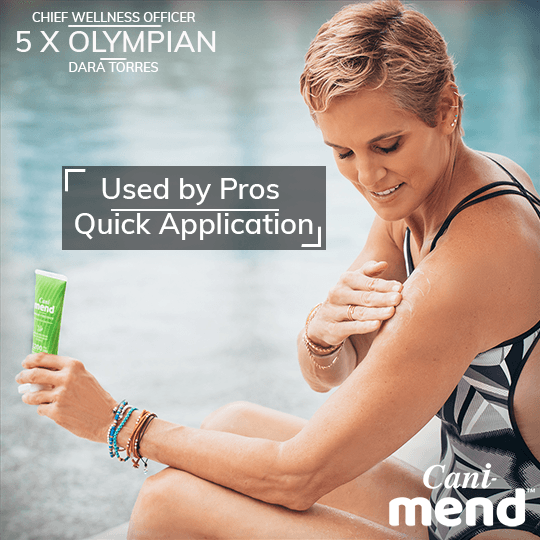 Alt=“Dara Torres applying a CBD muscle recovery cream on her arm”