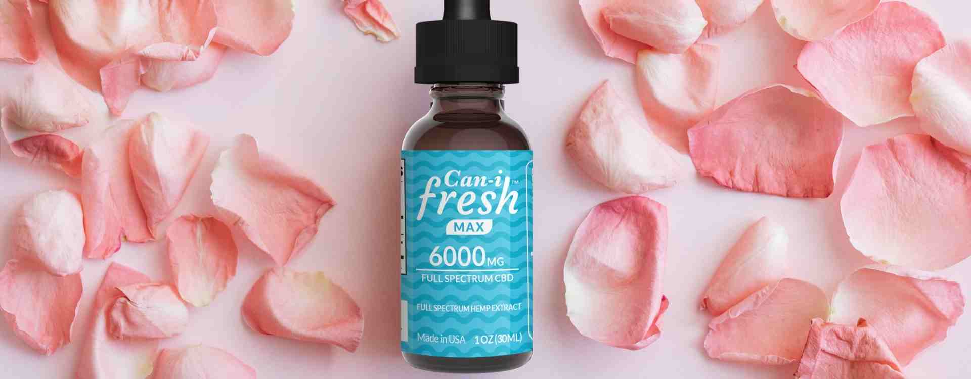 CBD oil tincture for stress relief and relaxation surrounding by pink petals”